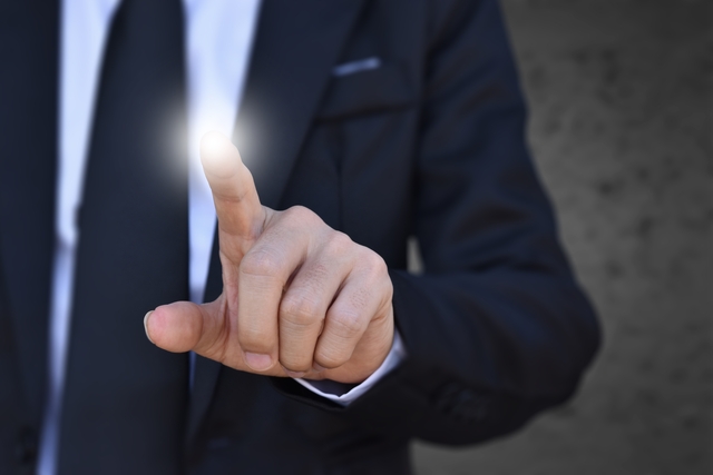 Businessman finger pressing an imaginary screen. Idea for business, technology, internet and networking.